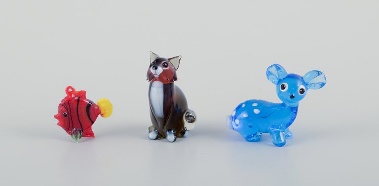 Murano, Italy. A collection of three miniature glass animal figurines consisting of a deer, fish, and fox in colored art glass.