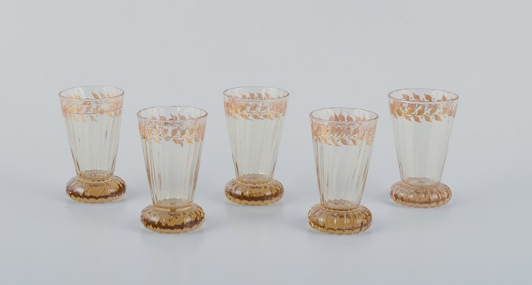 Emile Gallé (1846-1904), French artist and designer.Five small crystal glasses hand-decorated with gold leaf motifs.