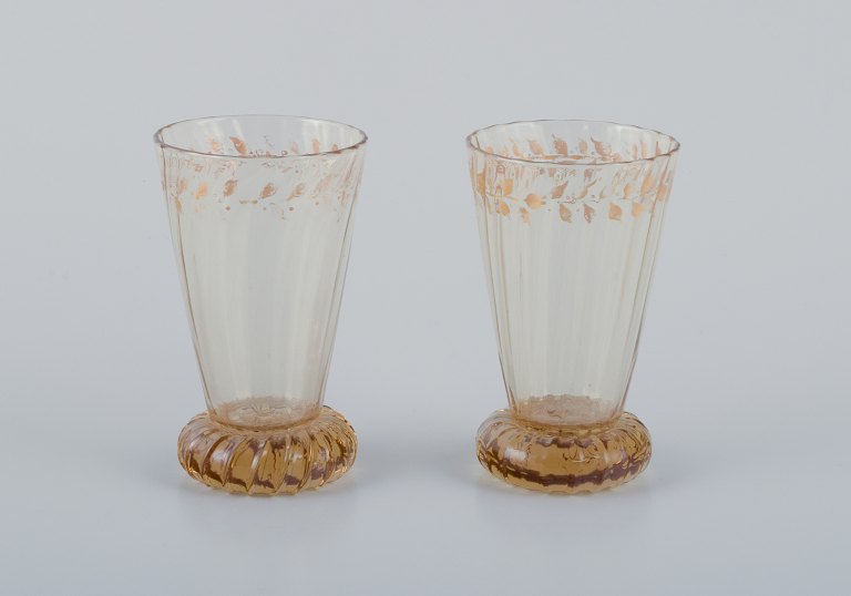Emile Gallé (1846-1904), French artist and designer.Two small crystal glasses hand-decorated with gold leaf motifs.