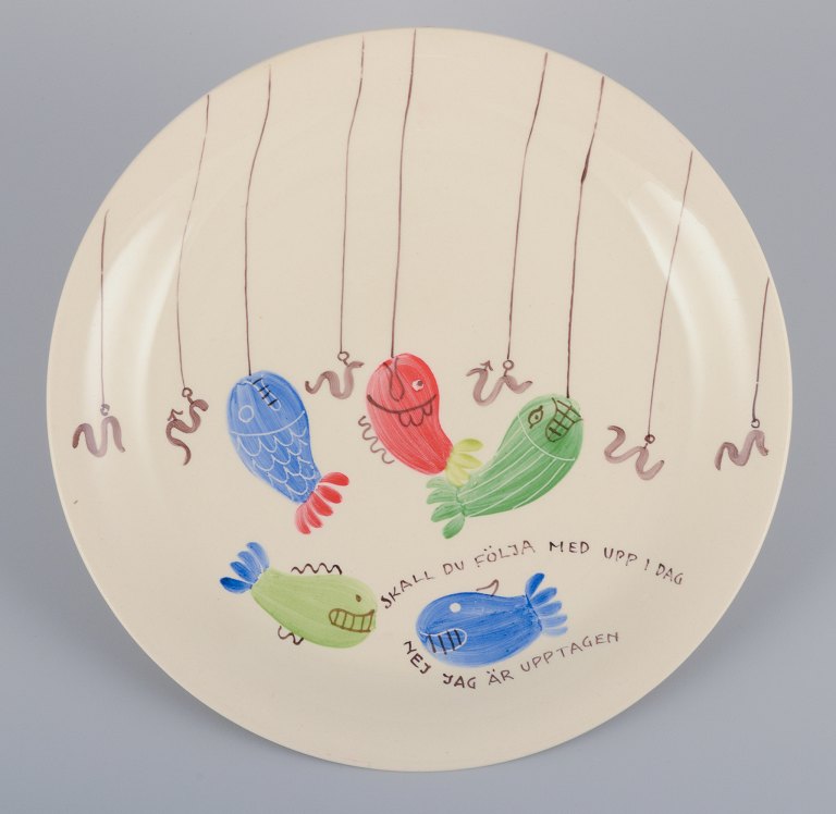 Stig Lindberg for Gustavsberg. "Löja" plate. Hand-painted with a fish motif. Satirical illustration with Swedish text.