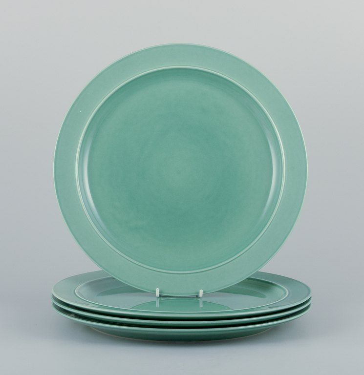 Royal Copenhagen, "4 All Seasons". A set of four dinner plates in faience with green glaze.