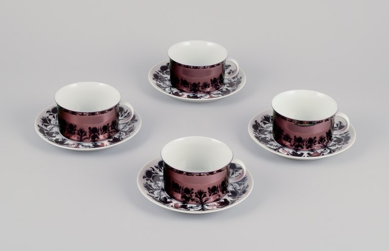 Bjørn Wiinblad for Rosenthal, Germany. A set of four "Berlin Hilton" coffee cups with saucers in porcelain. Glossy copper-colored decoration.