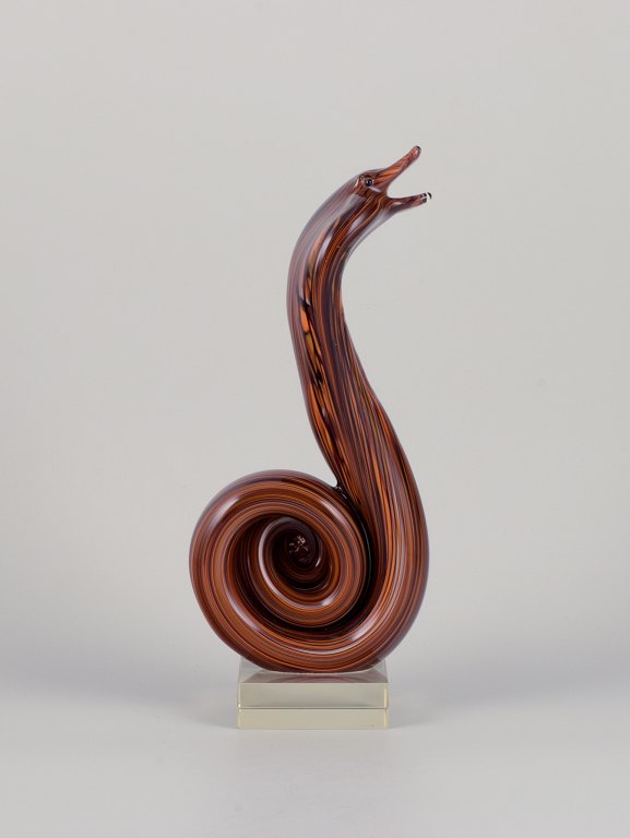 Murano, Italy. Large sculpture depicting a cobra snake crafted in art glass. The glass features brown and orange tones with a clear glass base.