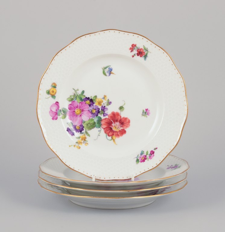 Royal Copenhagen, a set of four Saxon Flower porcelain plates.Hand-painted with various polychrome flower motifs and gold rim.