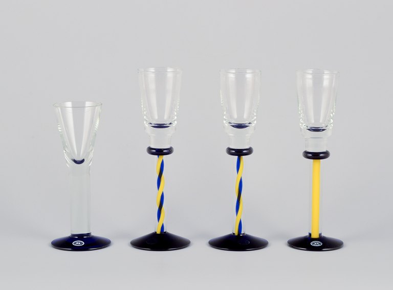 Margareta Hennix for Reijmyre, Sweden. A set of four schnapps glasses. Handmade and mouth-blown art glass in blue, yellow, and clear glass.