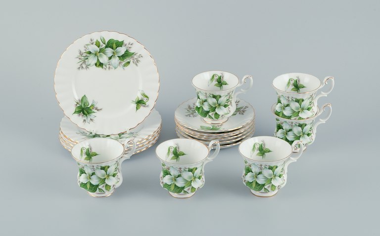Royal Albert, England. A set of six "Trillium" coffee cups with saucers and cake plates. Decorated with flowers and gold trim.
