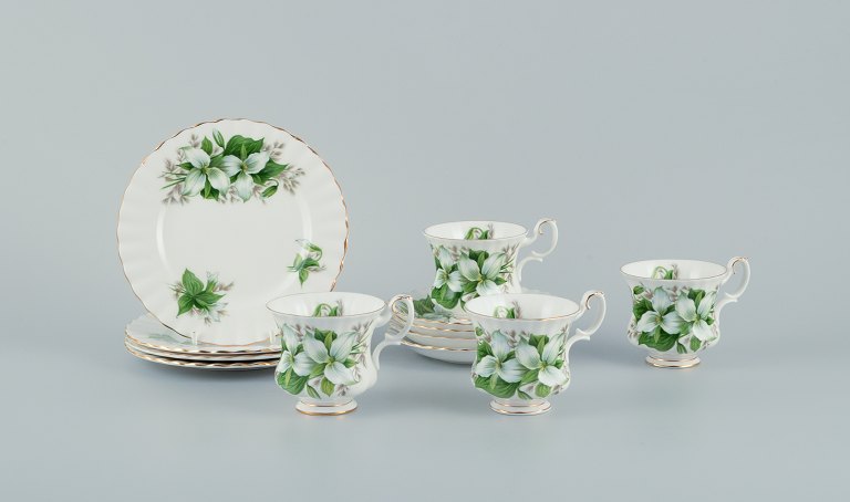 Royal Albert, England. A set of four "Trillium" coffee cups with saucers and cake plates. Decorated with flowers and gold trim.