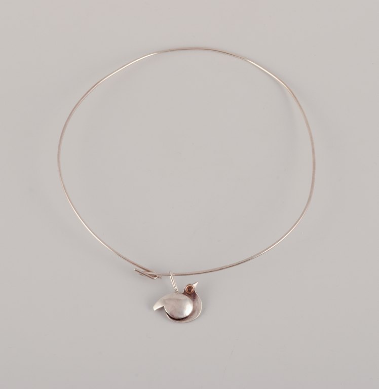 Inga-Britt "Ibe" Dahlquist. Modernist neck ring in sterling silver.Pendant shaped like a bird.