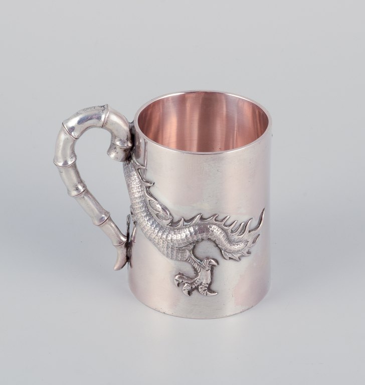 Luen-Wo, Shanghai. Silver cup with handle. Relief dragon motif. Handle resembling bamboo.