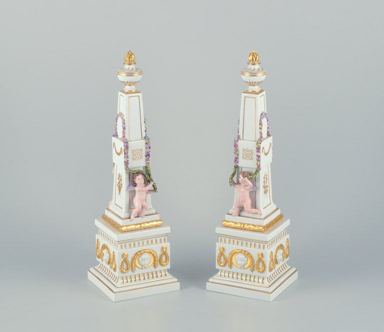 Royal Copenhagen Flora Danica, a pair of obelisks for table decoration.Putti surrounded by garlands, budding flowers.