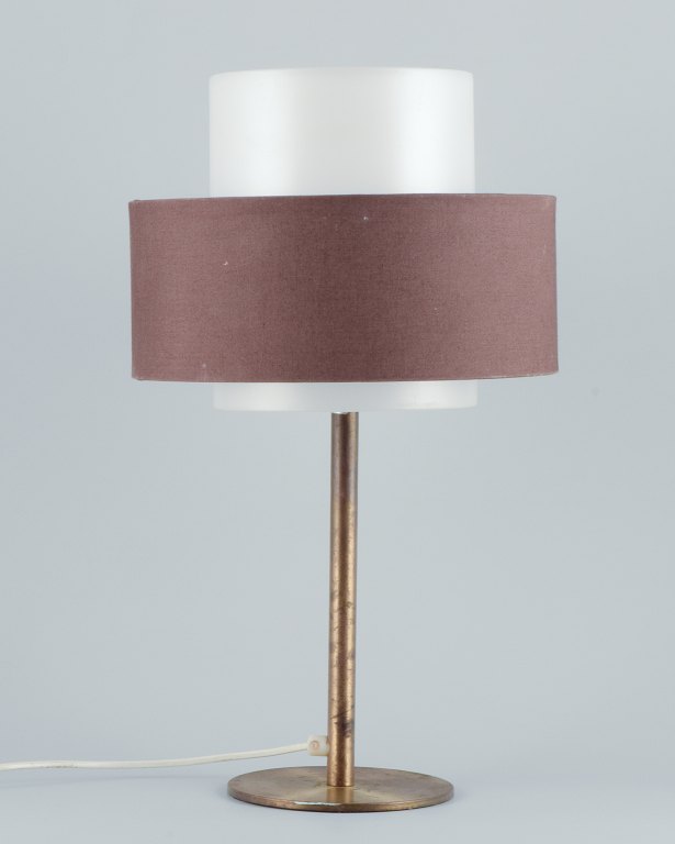 Luxus, Sweden. Large table lamp in brass with a shade in plastic and brown fabric.