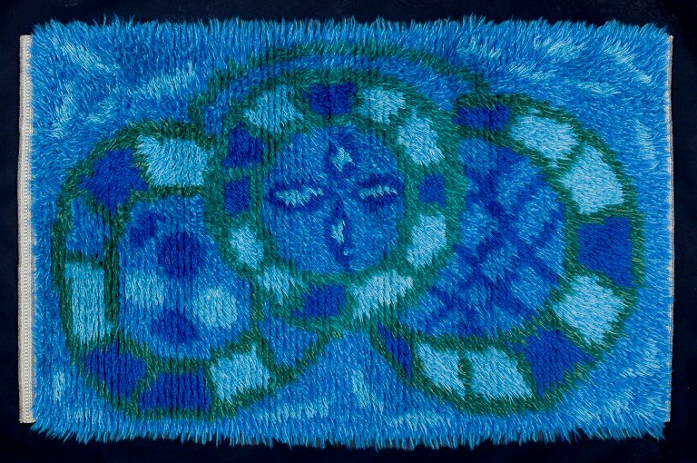 Swedish designer, handwoven rya carpet.Geometric pattern in blue, violet, and green colors.