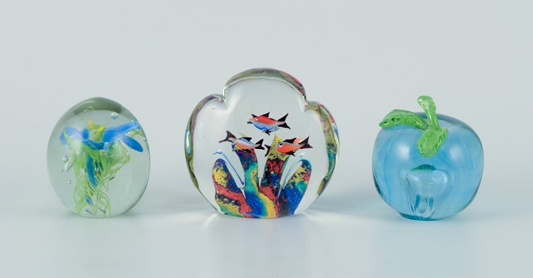 Scandinavian glass artist. Set of three paperweights in art glass. Flower motif, aquarium, and apple embedded in the glass. Handmade.