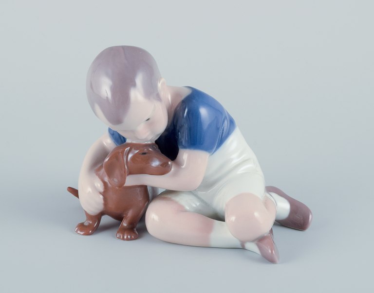 Ingeborg Plockross Irminger for Bing & Grøndahl, porcelain figurine of a boy with a dachshund.