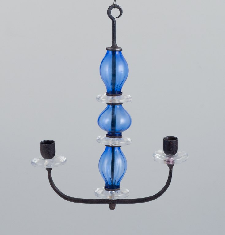 Erik Höglund (1932-1998) for Kosta Boda, Sweden. Rare two-armed hanging candle holder in cast iron and mouth-blown art glass.