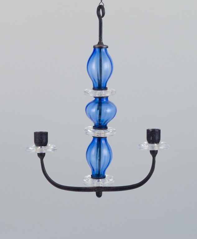 Erik Höglund (1932-1998) for Kosta Boda, Sweden. Rare two-armed hanging candle holder in cast iron and mouth-blown art glass.