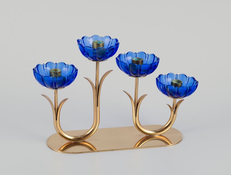 Gunnar Ander for Ystad Metall, Sweden. Candlestick holder in brass and blue art glass shaped like flowers. For four candles.
