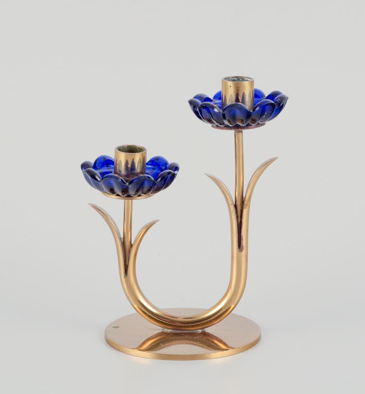 Gunnar Ander for Ystad Metall, Sweden. Candlestick holder in brass and blue art glass shaped like flowers. For two candles.
