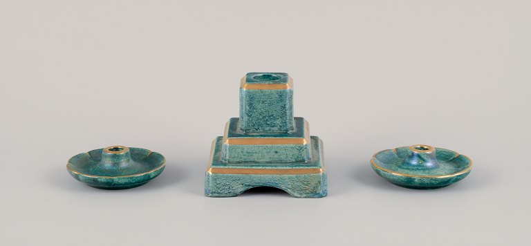 Josef Ekberg (1877-1945) for Gustavsberg, Sweden. Three candle holders with glaze in green-blue tones, gold decoration.