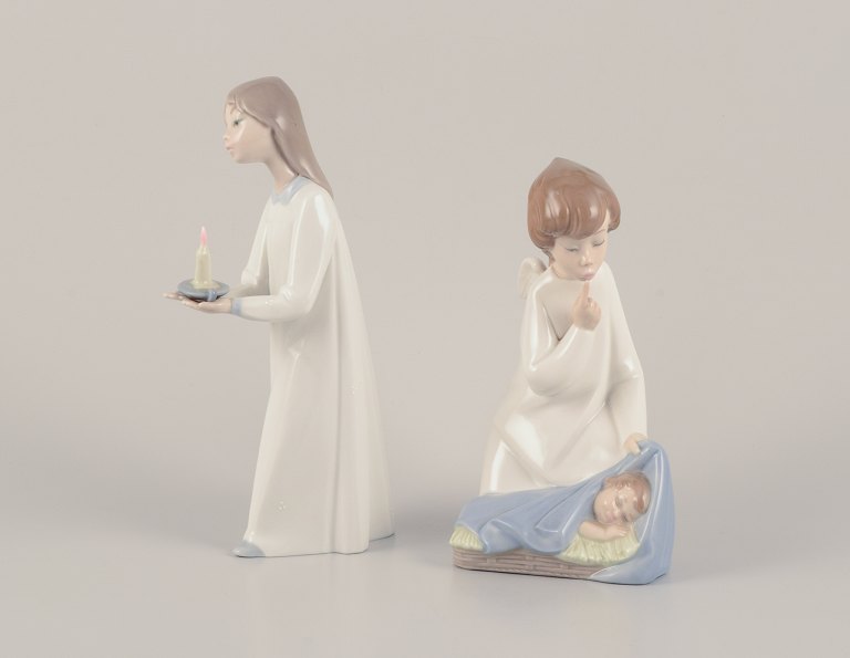 Lladro, Spain. Two porcelain figurines. Girl with a nightstand lamp and an angel figurine with a sleeping child.