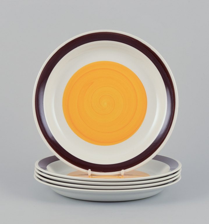 Carl Harry Stålhane (1920-1990) for Rörstrand, Sweden. A set of five deep "Solöga" (Sun Eye) dinner plates in earthenware.