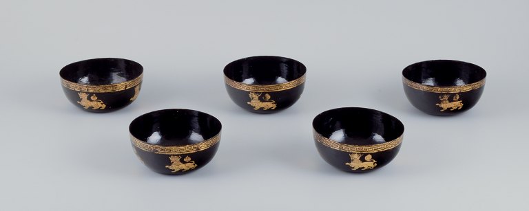 Five Asian bowls made of papier-mâché. Decorated in gold and black with traditional motifs.