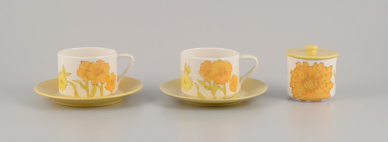 Ernestine Salerno, Italy. Two large coffee cups/morning cups with saucers and a lidded jar. Hand-painted with sunflowers.