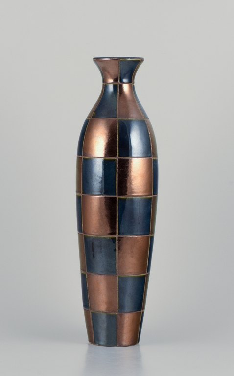 French ceramic artist. Large unique ceramic vase in a modernist design.Square sections in blue and gold-tone glossy glaze.