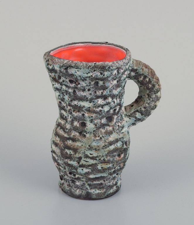 Vallauris, France. Small ceramic pitcher. Raku fired glaze with an orange interior.