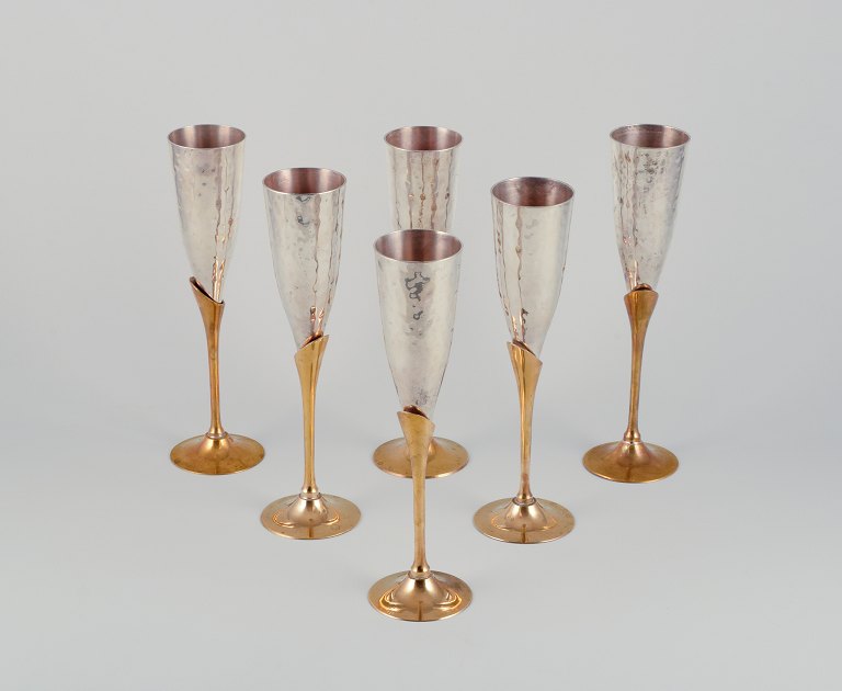 Swedish designer. A set of six champagne glasses in brass and silver-plated brass. Handcrafted.