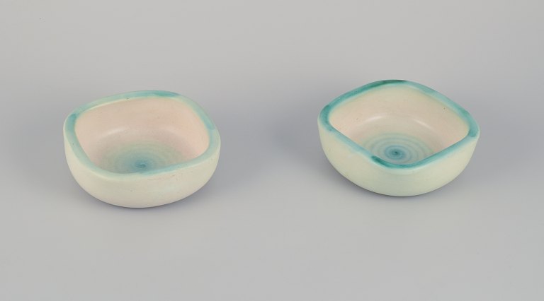 Elchinger, France. Two ceramic bowls with light-toned glaze. Hand-decorated. Spiral-shaped decoration.