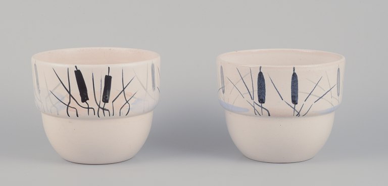 Paul Milet for Sevres, France. A pair of unique ceramic plant pot holders. Hand-decorated with cattails.