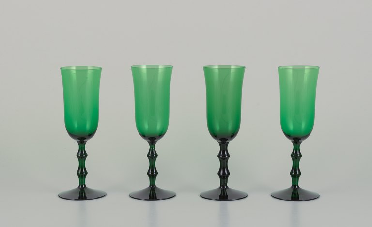 Simon Gate for Orrefors, Sweden. Four "Salut" champagne glasses in green mouth-blown art glass.