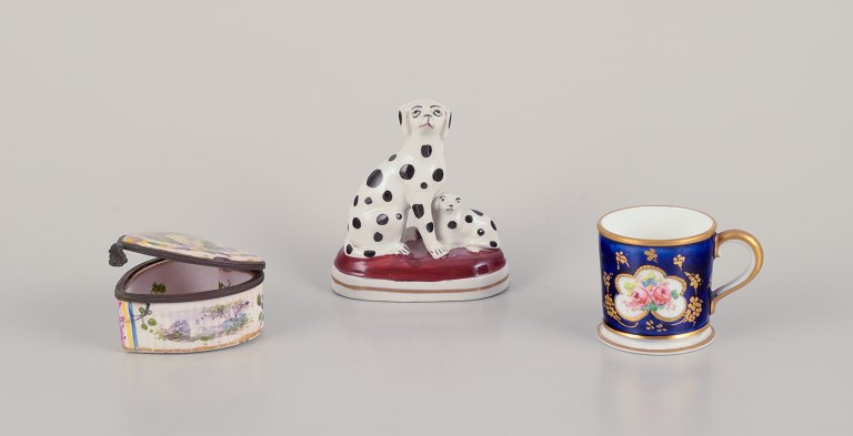 Three pieces of French and English porcelain including a Royal Crown Derby miniature cup, a miniature porcelain figurine of two Dalmatians, and a JACQUES FEBVRIER Manufactory signed "LILLE, 1763" Small Faience box.
