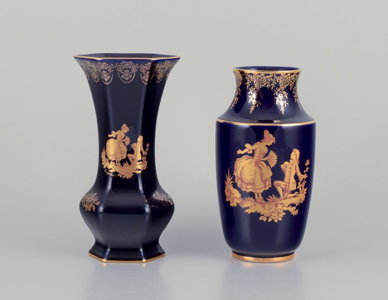 Limoges, France. Two porcelain vases decorated with 22-karat gold leaf and beautiful royal blue glaze. Scène galante.