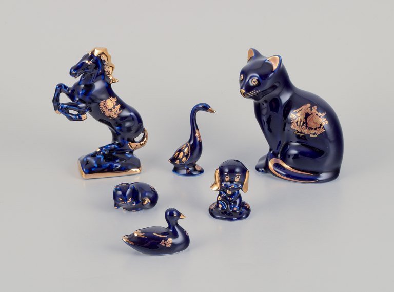 Limoges, France. Six porcelain miniature animals, decorated with 22-karat gold leaf and a beautiful royal blue glaze. Scène galante.