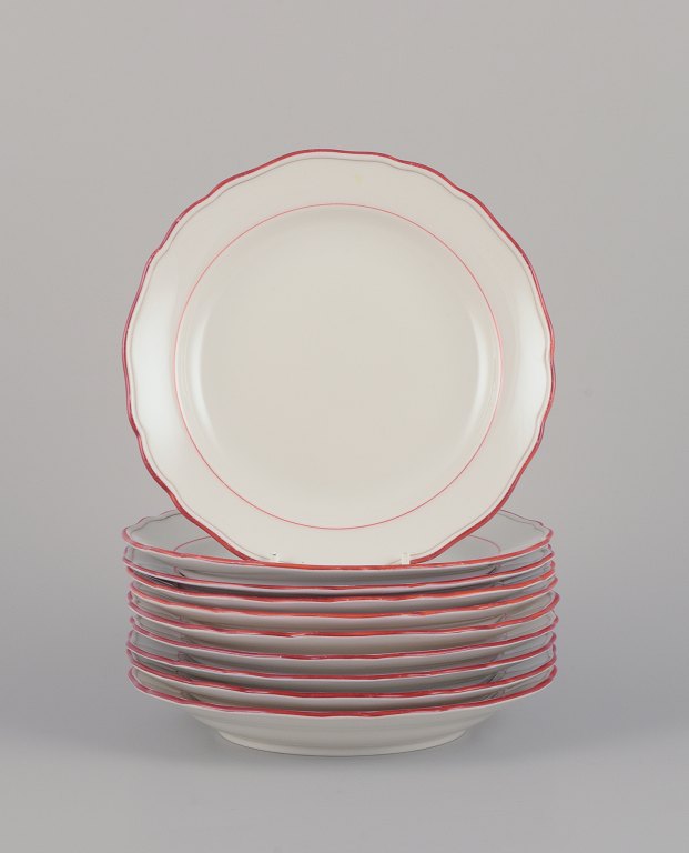 Meissen, Germany. A set of ten plates. Decorated with coral red and gold-colored trim. Art Deco.