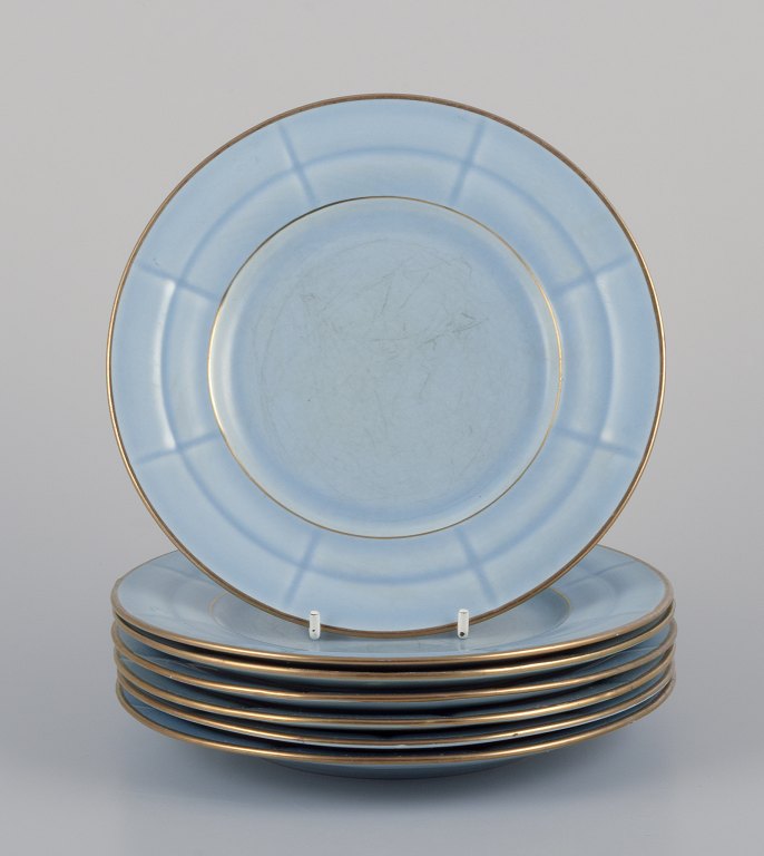 Arthur Percy for Gefle, Sweden. Seven Art Deco "Grand" plates in pastel blue porcelain with hand-painted gold trim.