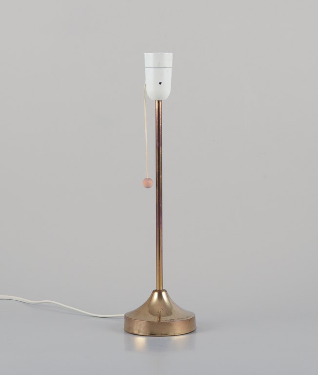 Nybro Armaturfabrik, Sweden. Brass table lamp.Sleek Scandinavian design with wooden toggle switch.