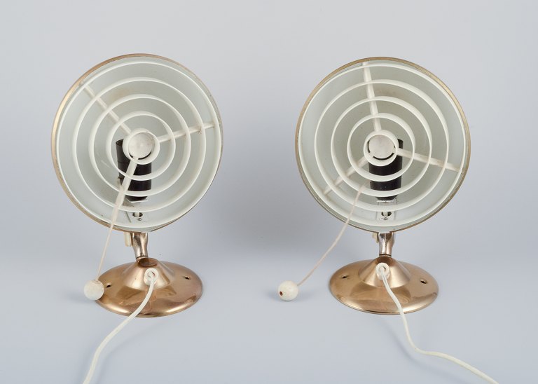 Knud Chistensen for "Elit," Denmark.A pair of modernist wall lamps in brass with plastic shades.