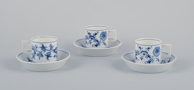 Meissen, Germany. Blue Onion. A set of three small chocolate cups with saucers. Hand-decorated with blue flowers.