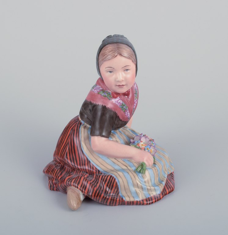 Royal Copenhagen, regional figurine of a girl from Faroe Islands. Overglaze. Dressed in regional costume and holding a bouquet of flowers.