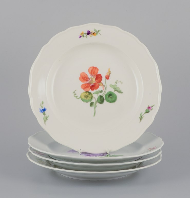 Meissen, Tyskland.A set of four dinner plates. Hand-painted with different floral motifs.