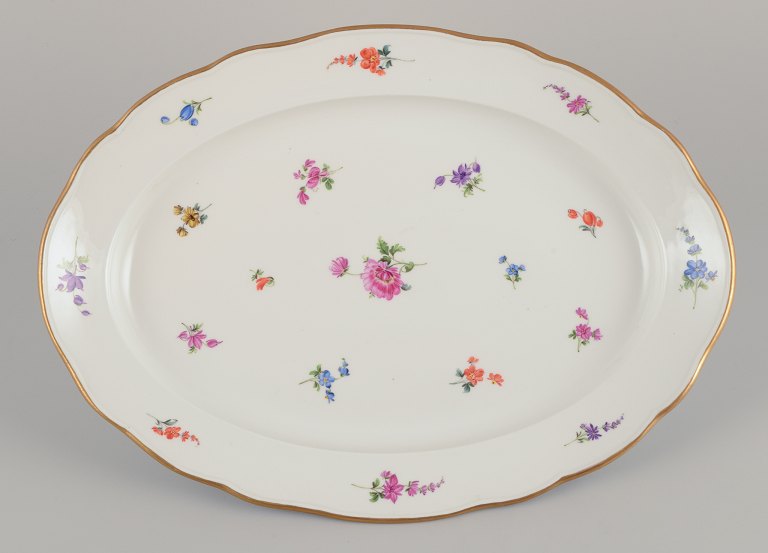 Meissen, Germany. Large oval serving platter in porcelain.Hand-painted with polychrome floral motifs.