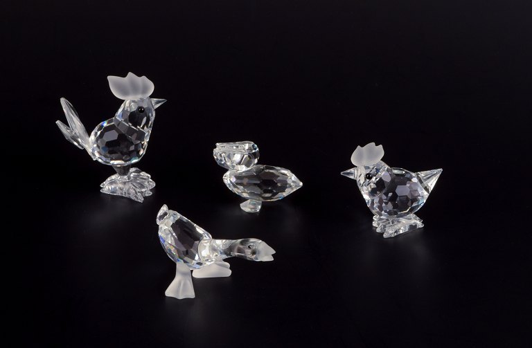 Swarovski, Austria.Four miniature figures in faceted cut crystal glass.