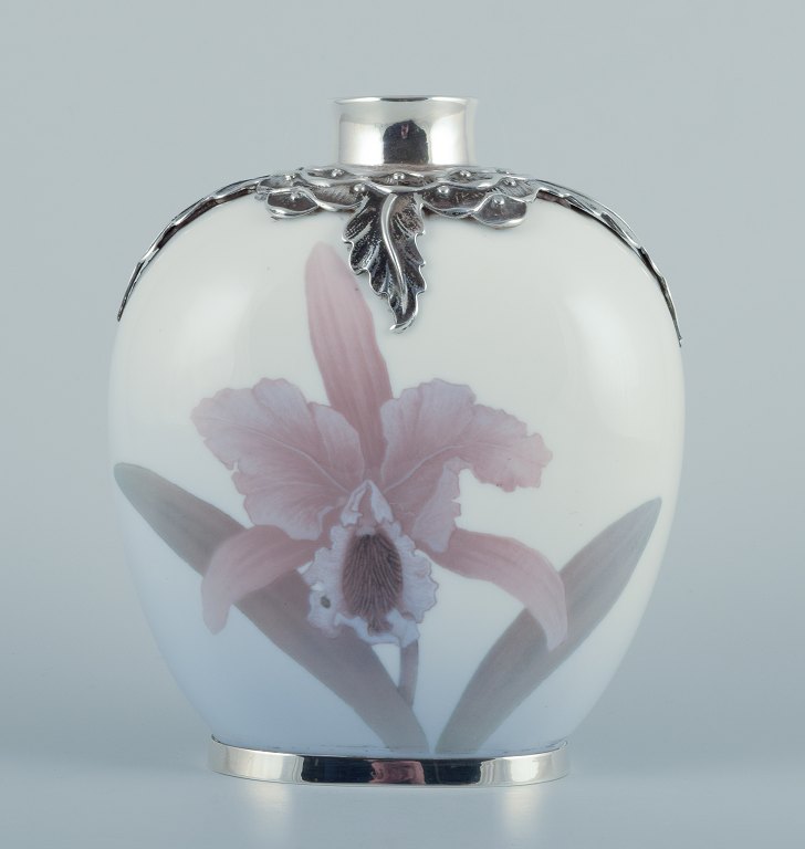 Royal Copenhagen, Art Nouveau vase in porcelain with sterling silver inlaids at the top and bottom.