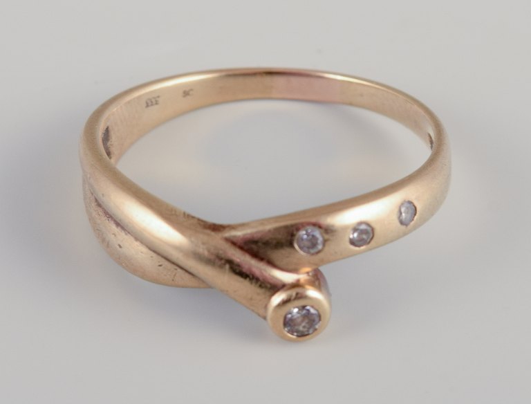 Danish goldsmith. 8 karat gold ring.Adorned with four brilliant-cut diamonds.