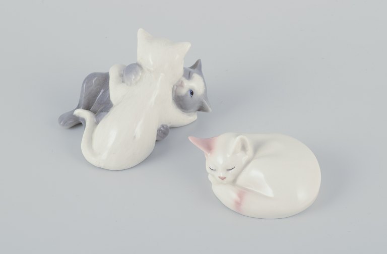 Royal Copenhagen mini collection, two porcelain figurines of sleeping kittens and a figurine of playing kittens.