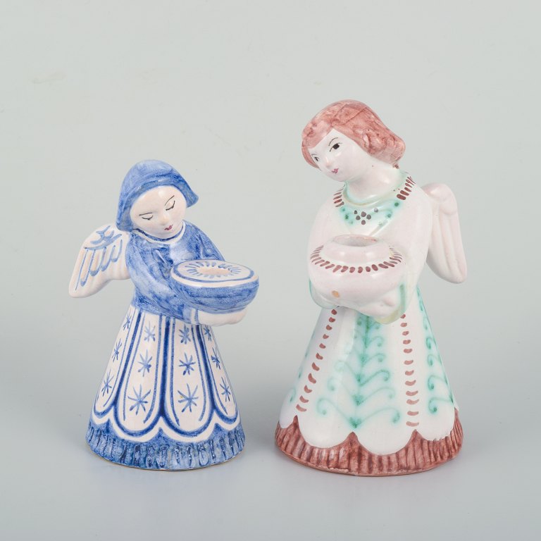 Two Hjorth ceramic candlesticks in the shape of angels, executed in glazed faience.