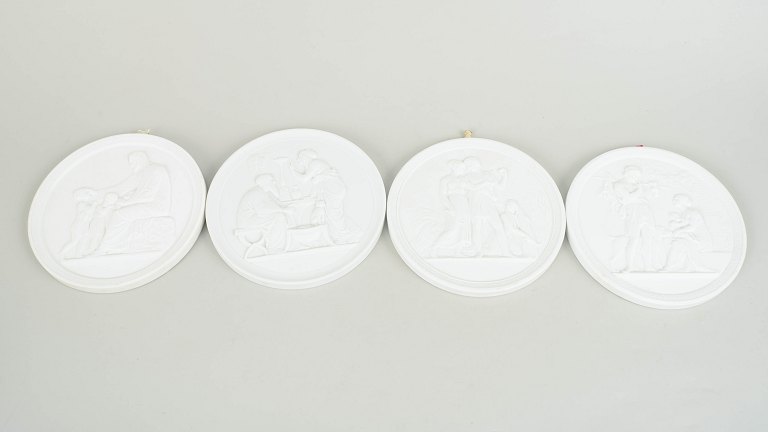 Royal Copenhagen, set of four biscuit wall plaques after Thorvaldsen.